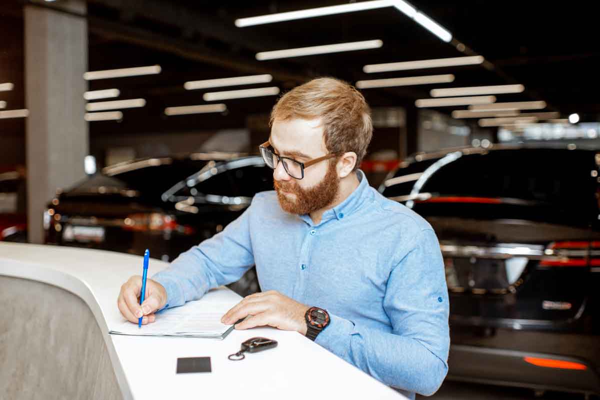 man-buying-a-new-car-at-the-dealership-2022-01-18-23-44-59-utc